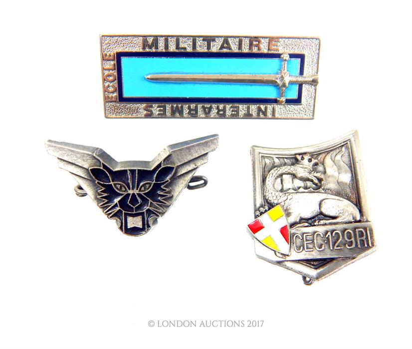 Three French metal badges: a French Ecole Militaire Interarmes badge by Arthus-Bertrand Paris; a