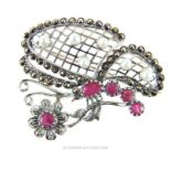 A silver butterfly brooch set with rubies.