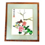 A Chinese silk embroidered with birds and flowers; signed; sight size 25cm x 20cm.