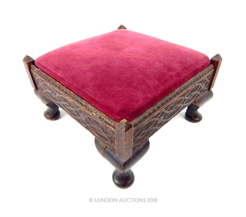 A late 19th century, Gothic-style, hand-carved footstool