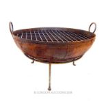 A cast metal indian fire pit grate; 81cm diameter.