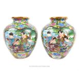 A pair of Japanese vases; decorated with women at the water's edge; 22cm high.