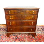 A walnut chest of four long drawers with boxwood line inlaid detail