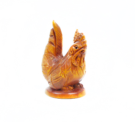 A carved wooden netsuke of a cockerel, signed base.