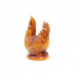 A carved wooden netsuke of a cockerel, signed base.