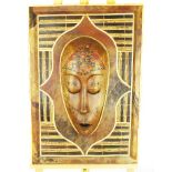 A carved and painted hardwood tribal mask, mounted on a bamboo decorated frame