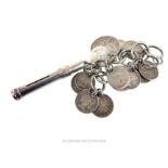 A sterling silver, vintage, propelling pencil case with antique coins attached