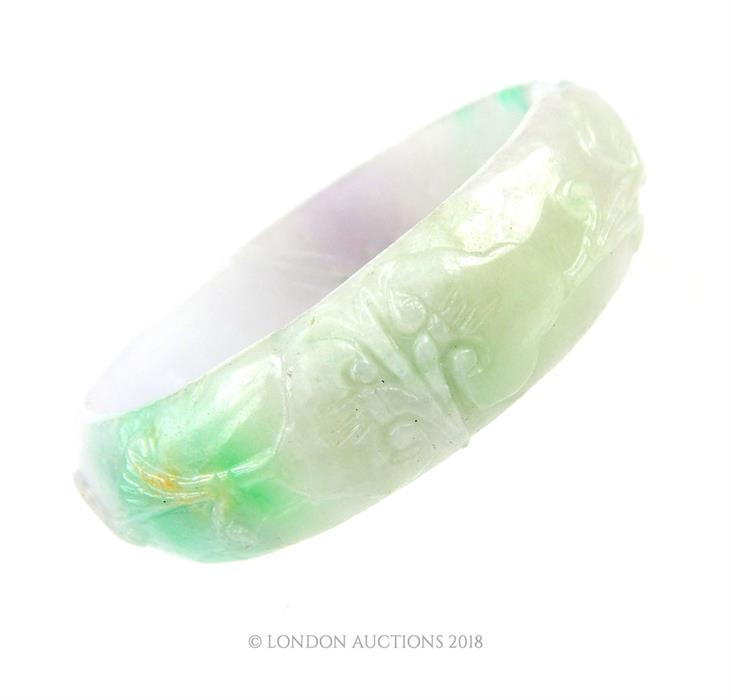 A carved Chinese jade bangle