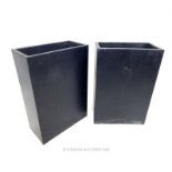 A pair of contemporary composite tall garden planters.