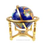 A contemporary semi precious stone globe on a brass stand