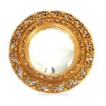 A vintage, carved, gilt-wood, circular wall mirror with convex glass panel