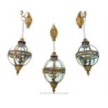 Three metal framed globe lanterns; each 42cm high.