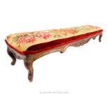 A 19th century, long upholstered foot stool; 116cm wide.