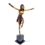 An Art Nouveau style, bronzed cast metal figurine of a female dancer raised upon a marble base; 48.