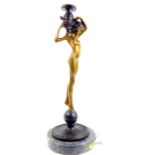 After Edward McCartan, a bronze candlestick in the form of a nude classical maiden