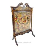 A late 19th century, Chinoiserie, lacquered fire screen with needle-point panel