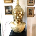 A large, composite, golden Buddha's head; 112cm high.