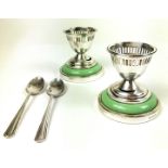 A pair of Art Deco, silver plated and green Bakelite egg cups and spoons