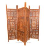 An exquisitely carved and pierced, Indian, four-folding, hardwood screen