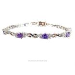 An elegant, sterling silver and purple zircon, cluster bracelet