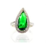 An attractive, sterling silver ring set with a large, deep-green, faceted zircon stone