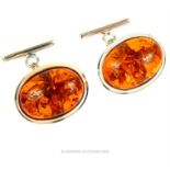 A pair of sterling silver and large, amber cabochon cuff-links