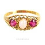 An 18 ct yellow gold, antique, ruby and natural opal ring