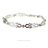 An elegant, 14 ct white gold, diamond and latticed-link bracelet