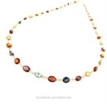 A 14 ct yellow gold, garnet, iolite and citrine studded necklace