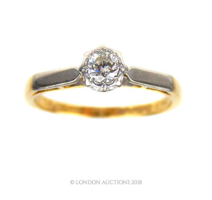 An 18 ct yellow gold and platinum, diamond solitaire ring