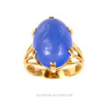 An 18 ct yellow gold and large, oval, blue cabochon stone dress ring