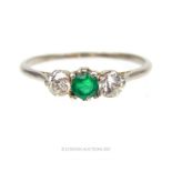 An early 19th century, white gold, emerald and double diamond ring
