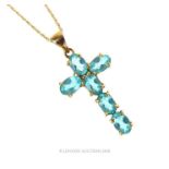 A 9 ct yellow gold and blue tourmaline crucifix