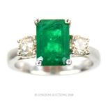 An 18 ct white gold, emerald and diamond ring