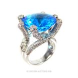 A 14th white gold, contemporary, diamond and blue topaz cocktail ring