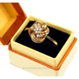 A boxed, 9 ct yellow gold and brilliant cut diamond, knot-shaped ring
