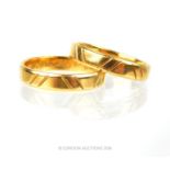 A matching pair of 18 ct yellow gold, engraved rings