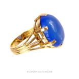 An 18 ct yellow gold and large, oval, blue cabochon stone dress ring