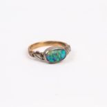 An Arts and Crafts, 14 ct yellow gold and natural black opal cabochon ring