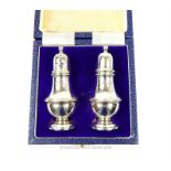 A pair of sterling silver salt and pepper shakers