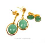 Two pairs of 9 ct yellow gold, green jade, oval cabochon earrings