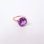 A 14 ct yellow gold and large, purple dichromatic corundum, solitaire ring