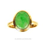 A 14 ct yellow gold and natural, green jade cabochon ring