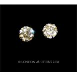 A pair of platinum and diamond solitaire stud earrings (0.30 carats tota