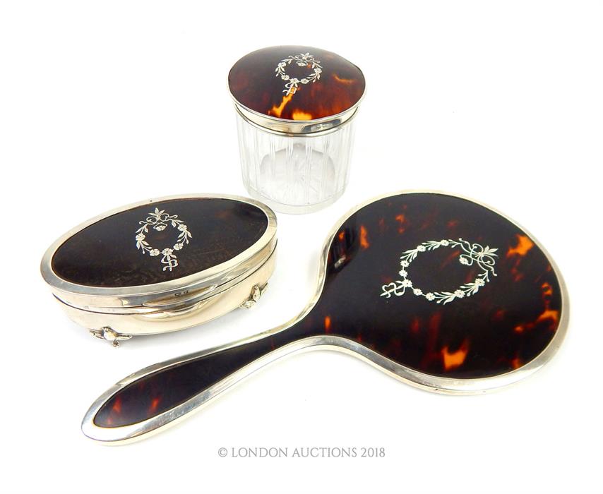 A set of three sterling silver and tortoiseshell dressing table items