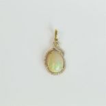 An 18 ct yellow gold, large opal and diamond pendant (9.4 carats)