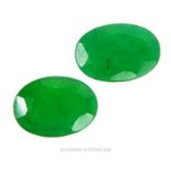 Two, natural, faceted, oval-shaped, emeralds