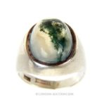 A chunky, sterling silver and moss agate cabochon ring