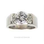 An 18 ct white gold, diamond solitaire ring with diamond set shoulders