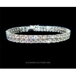 An 18 ct white gold, two row, diamond bracelet (9 carats approx)